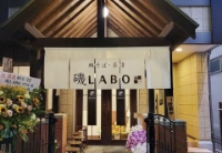 ARIFT読者投票2位に選ばれた鯛そば・茶漬 磯LABO 六町店の、白いのれんがかかったモダンな外観